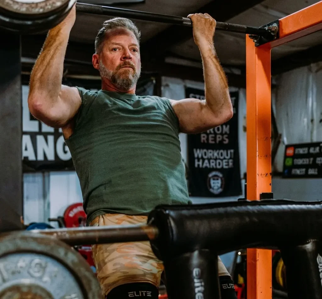 Iron Rooster Fitness coach performing an upper body strength training workout